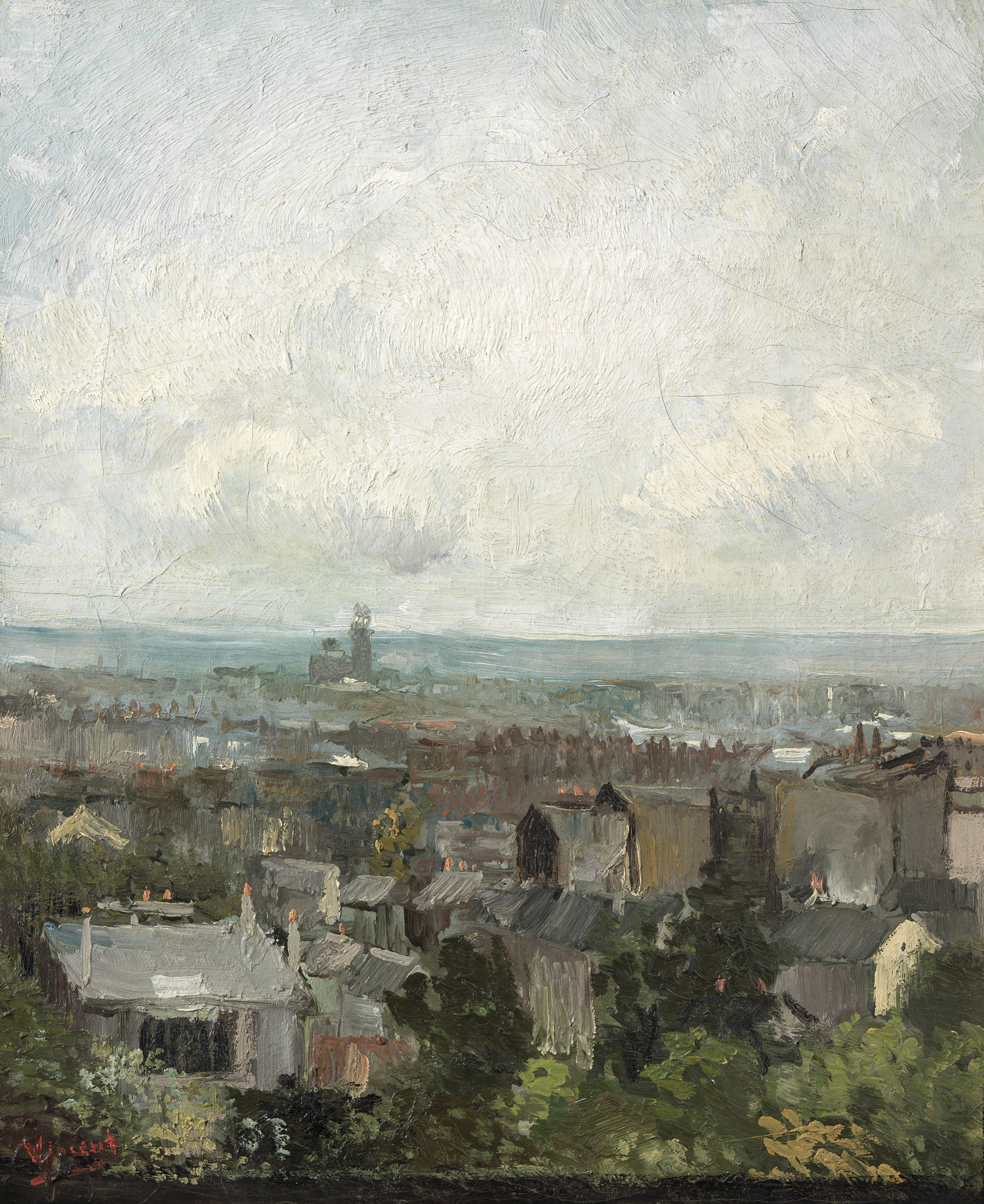 An expansive, cloudy sky above a scene of grey rooftops, with some trees. 