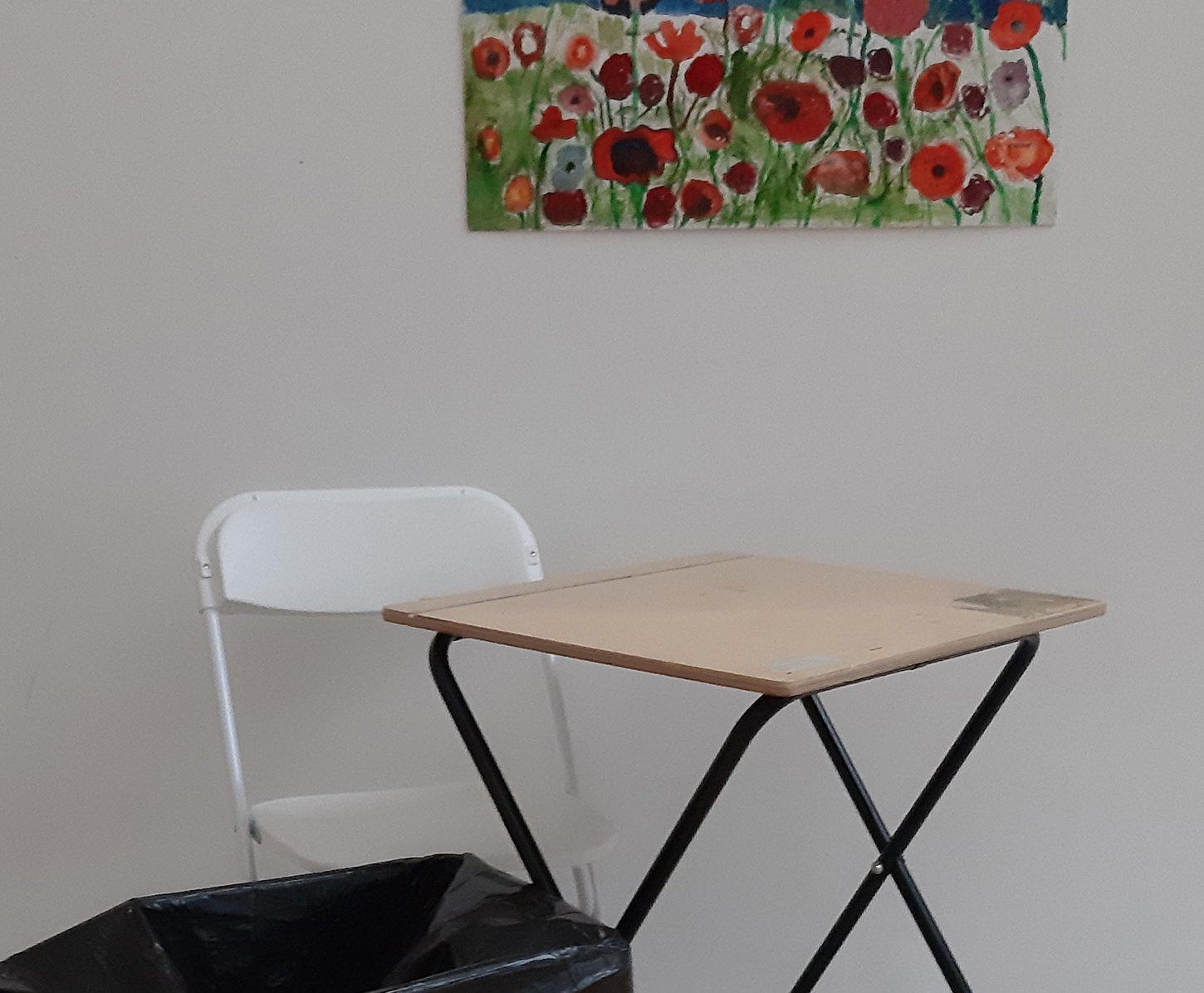 An example of a bad photo of an artwork. The painting is in the background and there is furniture blocking the view.
