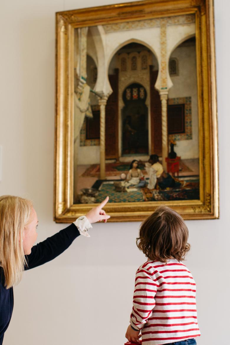 A child on a free tour of the permanent collection in the Millennium Wing in front of 'Women in an Eastern Courtyard'. © National Gallery of Ireland