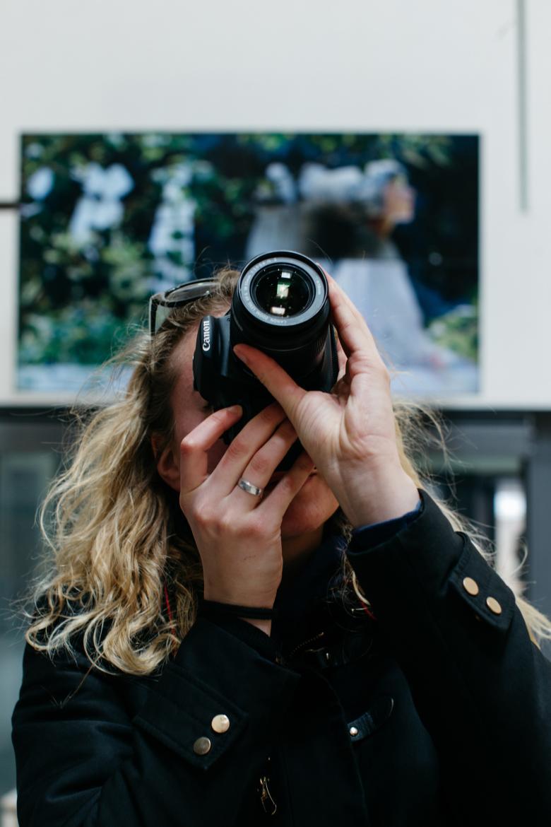 A visitor takes a photo in front of A Convent Garden by William Leech. © National Gallery of Ireland.