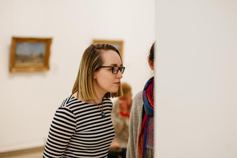 A visitor looking at artworks in the Millennium Wing. © National Gallery of Ireland.