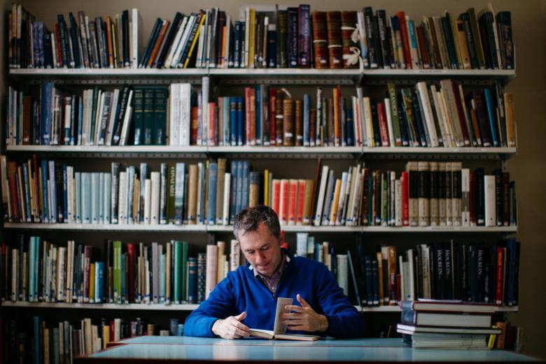 A man reading a book in a library