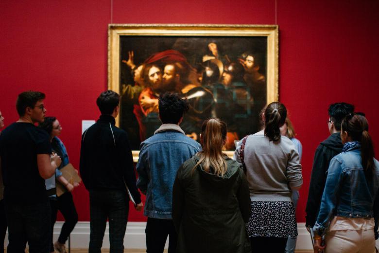 Visitors in front of the Taking of Christ in the exhibition Beyond Caravaggio. © National Gallery of Ireland.