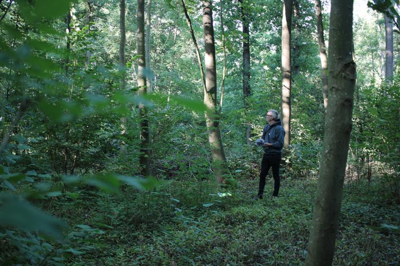 Artist Garrett Phelan recording sound in the field where the Battle of the Somme took place.