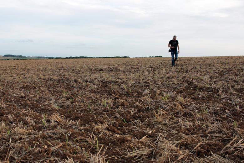 Artist Garrett Phelan recording sound in the field where the Battle of the Somme took place.