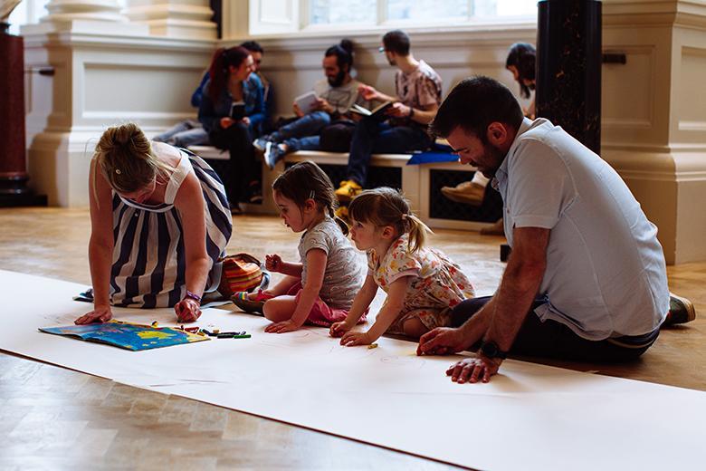 A family drawing together on the floor of the Shaw Room of the National Gallery of Ireland on National Drawing Day 2018.