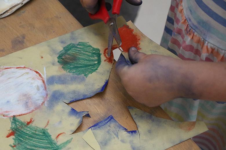Close-up of a child's hand as they create art at a drop-in family workshop in the National Gallery of Ireland.