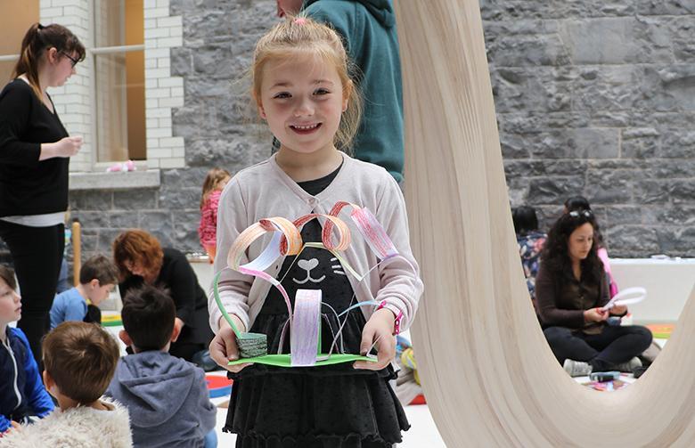 A young girl showing off the artwork that she created at a drop-in family workshop in the National Gallery of Ireland.
