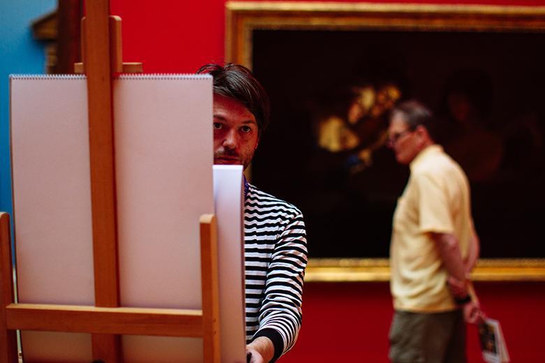A visitor working at an easel in the Gallery.
