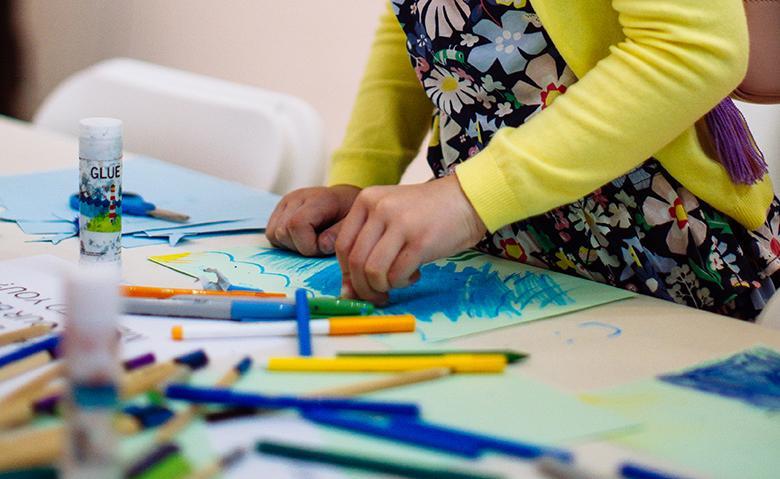 A child drawing during a drop-in family workshop at the Gallery.