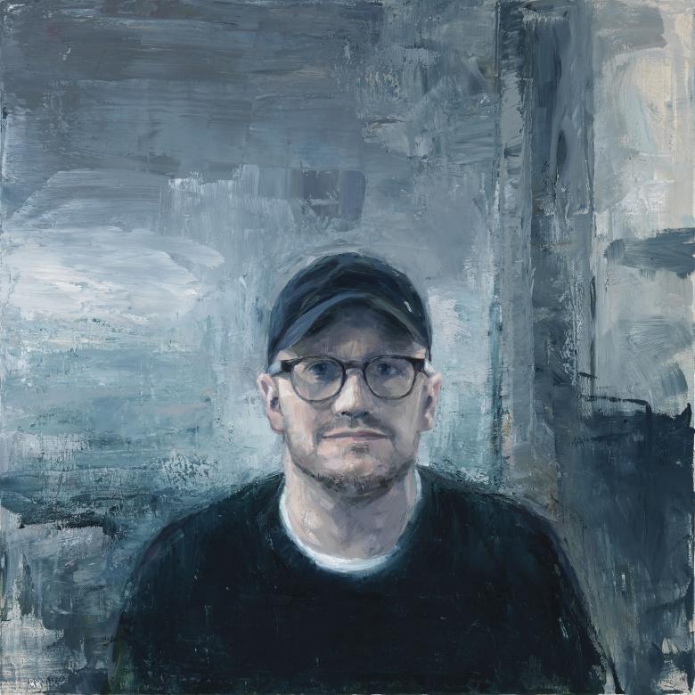 Painted head-and-shoulders portrait of Lenny Abrahamson wearing glasses and a baseball cap against a textured grey background.