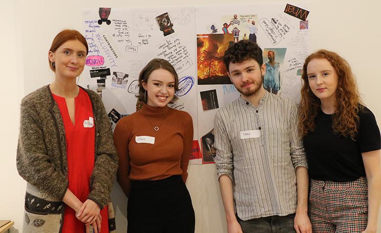 Photo of three young women and one young man posing in front of a collage