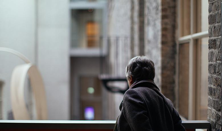 Photo of a woman looking over a balcony in the courtyard of the National Gallery of Ireland.