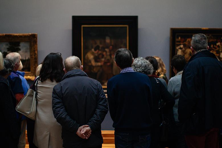Photo of a tour group looking at Dutch seventeenth-century paintings in the National Gallery of Ireland.