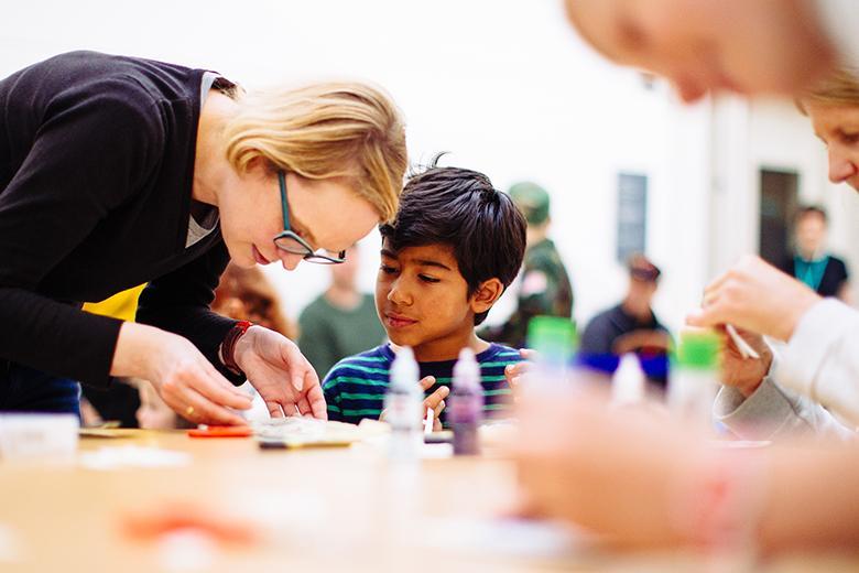 Photo of a young boy making art with a woman during a creative workshop at the National Gallery of Ireland.