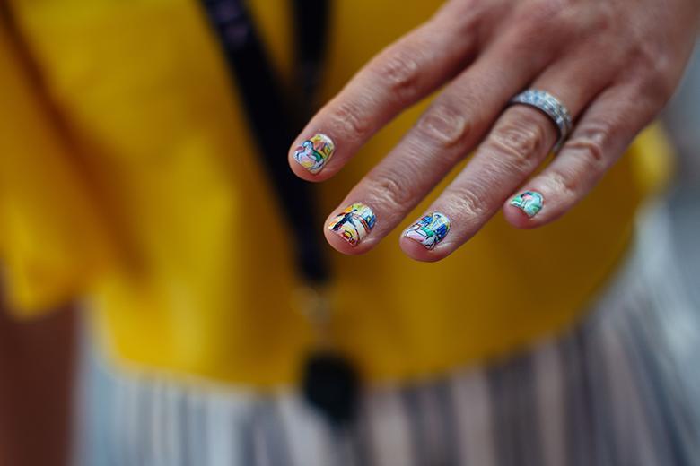 Photo of a woman's hand with nail art.
