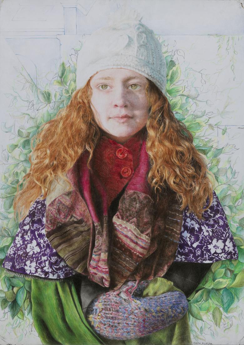 A young woman facing us, with her hands (in woolen mittens) clasped in front of her. She is wrapped in a number of different scarves, and wears a white wool hat. Her long auburn hair falls over her shoulders, and behind her there is green foliage.  