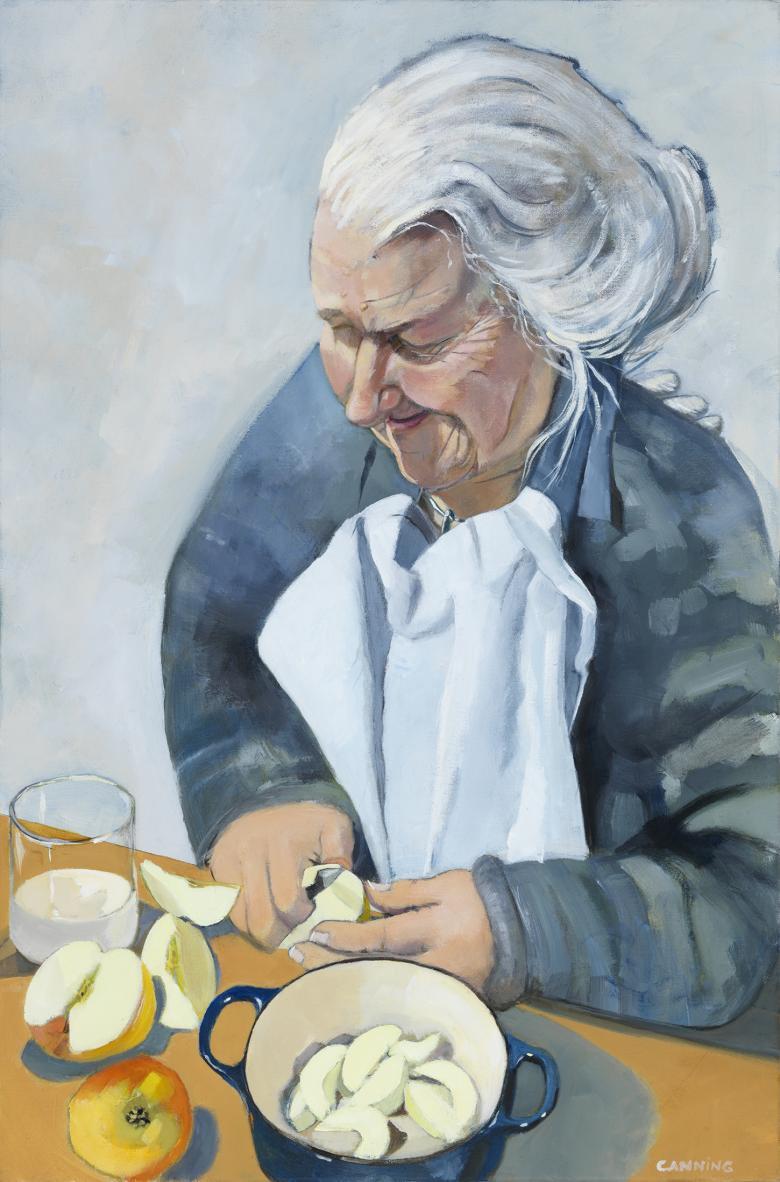 A woman stands over a counter, slicing and peeling apples and placing them in a pot in front of her. She has upswept grey hair, and is frowning in concentration.