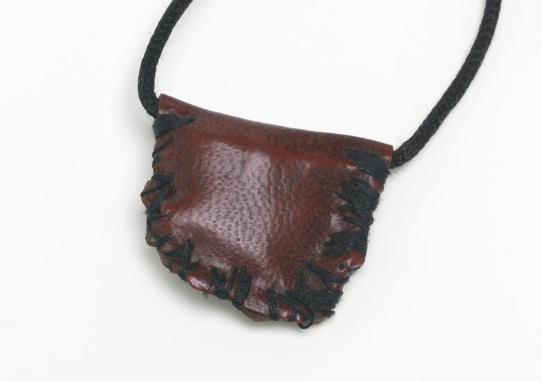 A red leather pouch hanging from a leather string