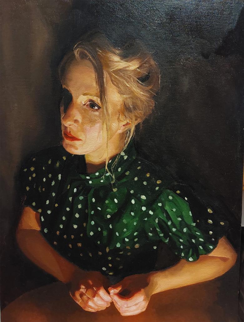 Painting of a female figure with blonde hair and a green spotted top in low light