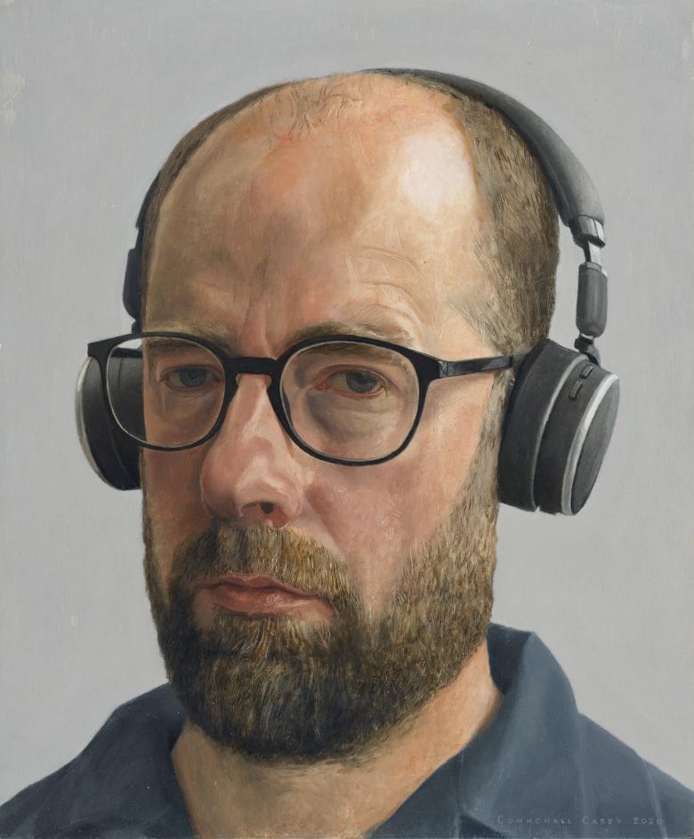 An oil portrait of a bearded man's head. He wears glasses and a large pair of headphones. His expression is sombre 