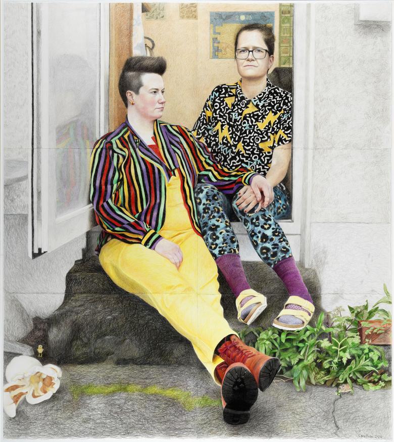 Two women sit in the doorway of a house, holding hands. The figure on the left wears yellow dungarees and a colourful striped blazer, and looks off to the right. The figure on the first has brightly pattered trousers and shirt, and purple socks. In the kitchen behind we see posters of bird and vegetable varieties are on the wall. In the left foreground, a surreally oversized piece of popcorn and tiny yellow chick.