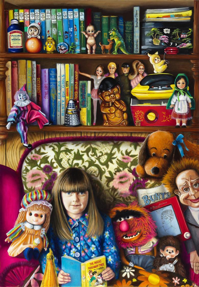 A young girl sits on a patterened sofa, surrounded by soft toys with more toys and books on the shelf behind her. She has a book open in front of her and looks directly at the viewer, smiling slightly.