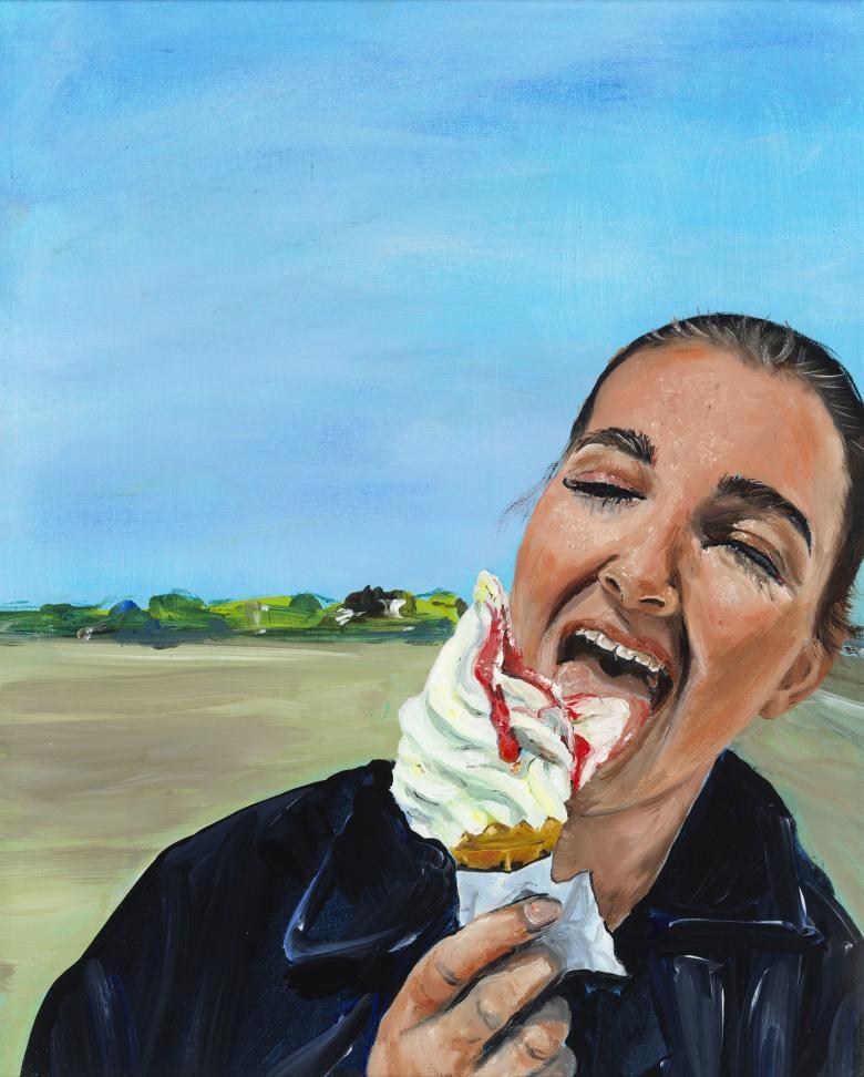 A young woman eats a 99 icecream with gusto, her eyes closed. Behind her, blue skies and a beach.