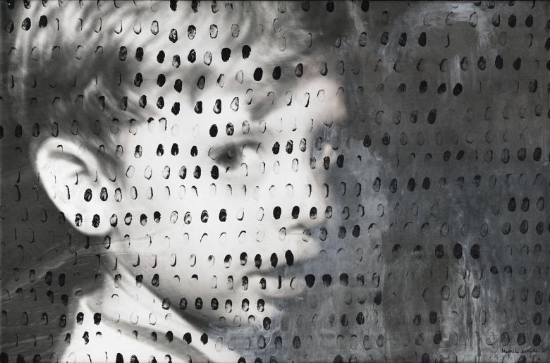 A black and white photograph of a young child's head in profile, looking at the viewer. The photograph is covered in black markings.