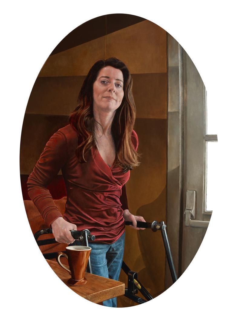 An oval-shaped portrait of a woman, wearing a red top and jeans and standing with the help of a walker. She looks directly at the viewer. On the table, a cup stands.