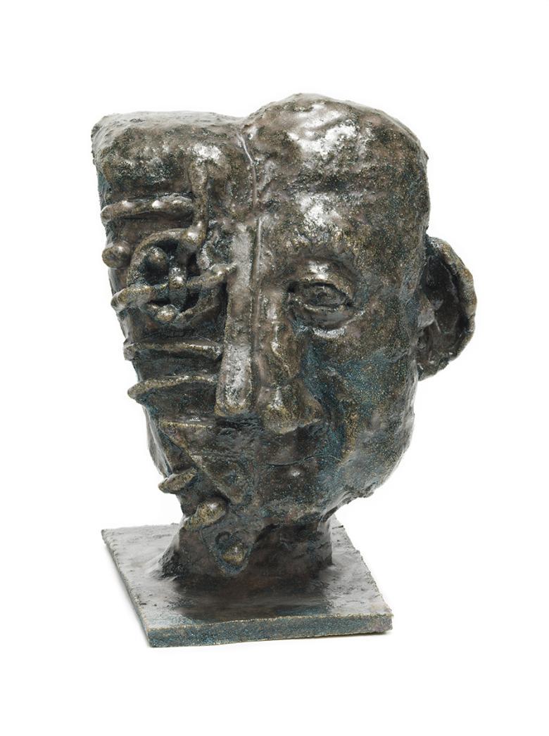 Sculpture of half a head of a male figure.