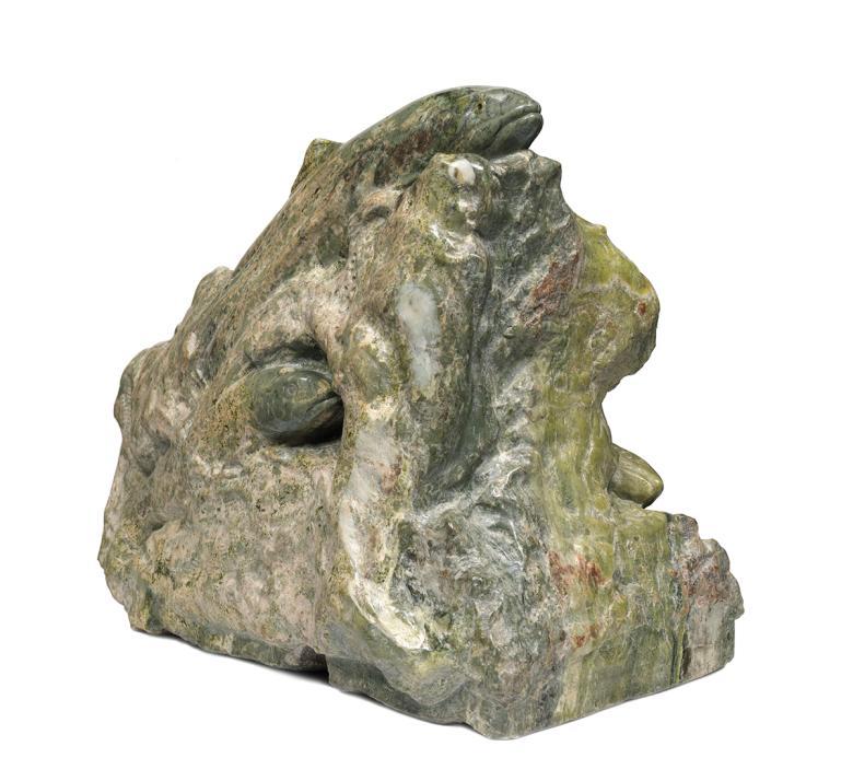 Green marble sculpture of a trout in a rier