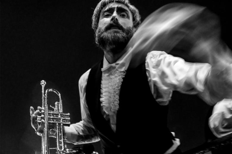 Photograph of a trumpet player in motion.