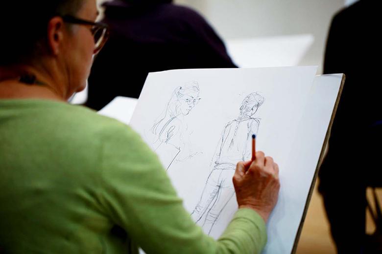 Woman drawing in the Gallery.