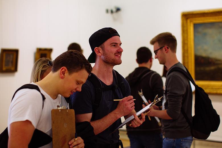 Two visitors drawing in the National Gallery of Ireland