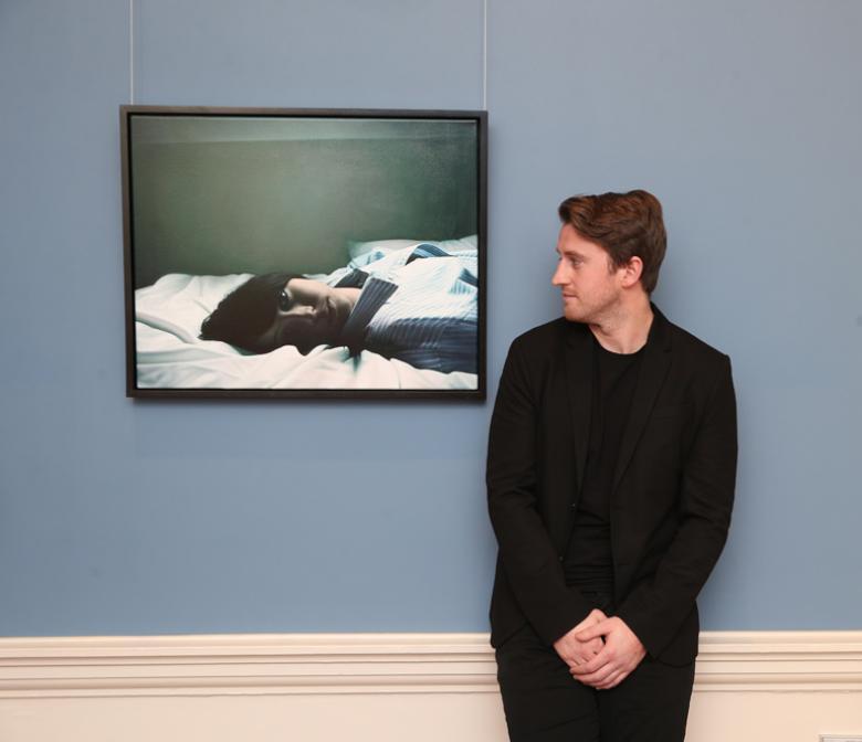 Hennessy Portrait Prize 2017 winner Jack Hickey, pictured in front of his winning painting, 'My Time'. Photograph by Leon Farrell.