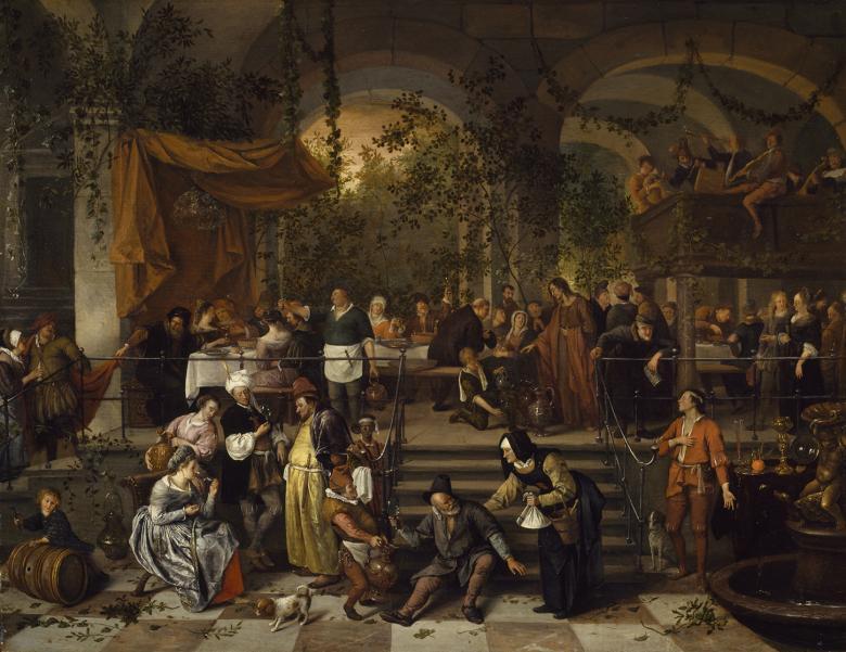 A banquet scene filled with figures. The table is set up beside large arches through which we can see trees and greenery.