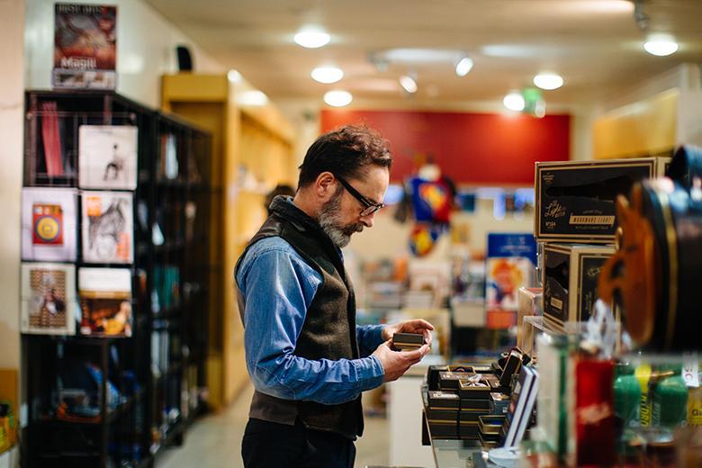 Photo of a man standing in the National Gallery of Ireland shop.