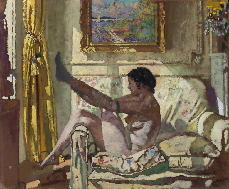 A woman sits on an armchair, naked, in a beam of sunlight, and puts on a stocking.