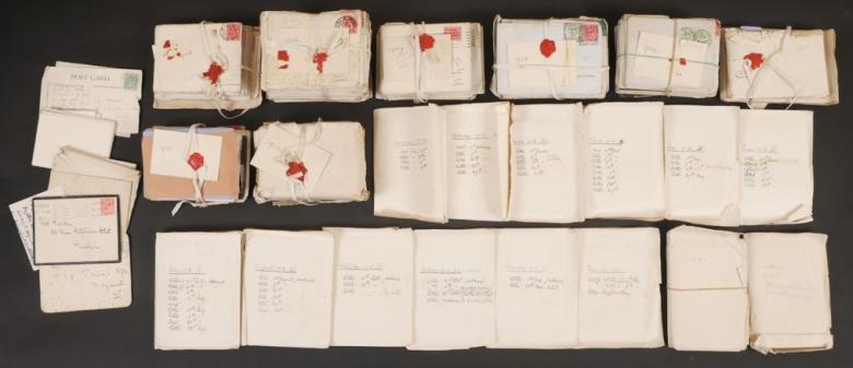 Aerial view of bundles of handwritten letters, some with red wax seals