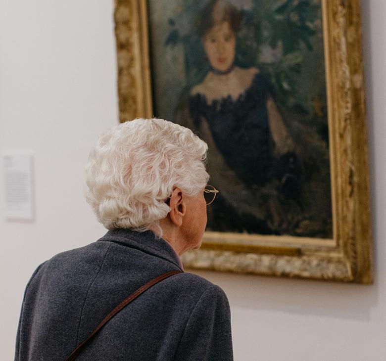 A visitor looking at Berthe Morisot's painting Corsage Noir in the Millennium Wing of the National Gallery of Ireland.