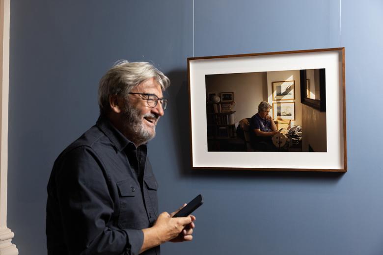 Fergal Keane smiling in front of his portrait by artist Enda Bowe in the National Gallery of Ireland