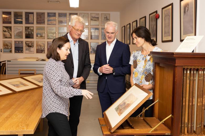 Gallery staff show Grant Thornton representative a watercolour by J.M.W. Turner