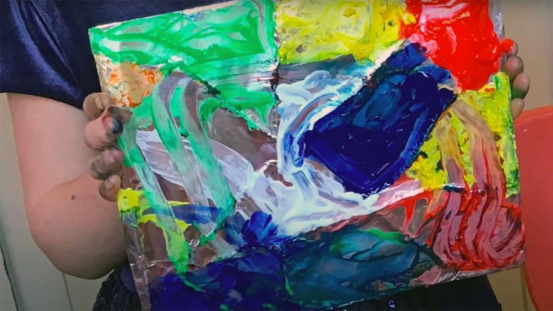 A stained glass inspired painting with colourful paint drawn by a child