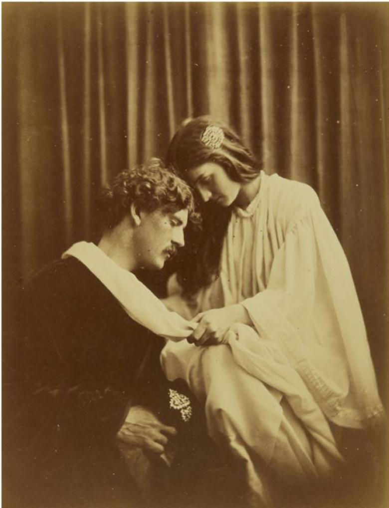 Albumen print showing a woman wrap fabric around a man's neck.