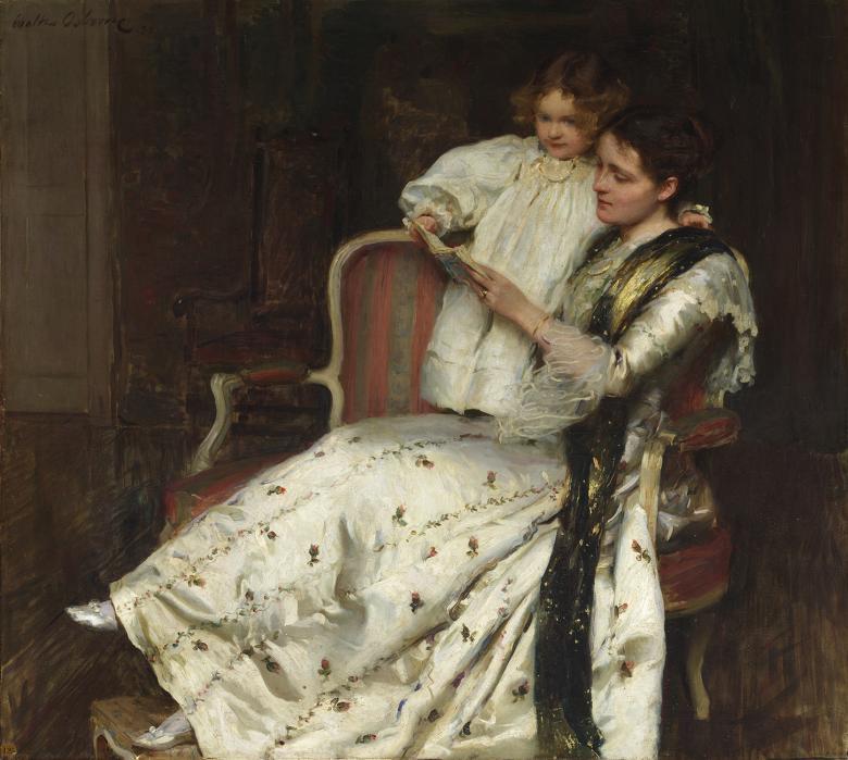 A woman in a long full-skirted white dress with small rosettes on it reclines on a chair. Standing beside her with her hand around her neck is a small child, also in white. They are both reading a book together.