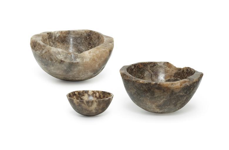 Three brown-hued bowls carved out of rock salt