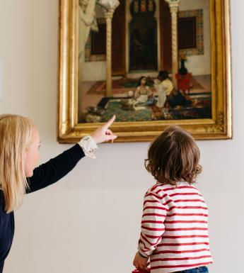 A child on a free tour of the permanent collection in the Millennium Wing in front of 'Women in an Eastern Courtyard'. © National Gallery of Ireland