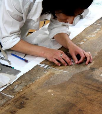 Working on a canvas in the conservation department. © National Gallery of Ireland