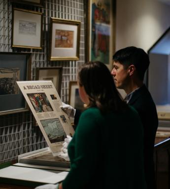 Two people looking at archival material